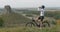 Professional Cyclist Makes Stop to Drink Water on the Hill with Beautiful View