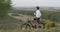 Professional Cyclist Makes Stop to Drink Water on the Hill with Beautiful View