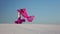 Professional dancer in the sandy desert in the hands of a pink pink veil. Slow motion