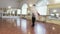 Professional dancers practicing ballet moves in studio, slow-mo