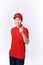 Professional delivery guy employee man in red cap T-shirt uniform workwear work as dealer courier showing thumb up like gesture