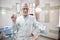 Professional dentist holding a big tooth replica in his hand