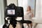 Professional digital camera recording video blog of businesswoma