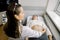 Professional doctor is examining female abdomen and kidneys using ultrasound equipment. Young caucasian woman patient is