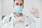 professional doctor in a medical mask holds a syringe in his hand vaccine coronavirus liquid chemistry