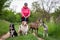 Professional dog walker with four dogs outdoors