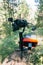 Professional DSLR Camera on 3-axis Gimbal Stabilization Device in Forest. Cinematographer Operator. Slow Motion