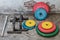 Professional dumbbells, multi-colored weight plates and push-up stops on a vintage background. Sports equipment. Healthy lifestyle