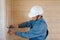 Professional electrical engineer performs installation of electrical sockets