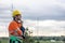 Professional Engineer male worker standing thinking hand at chin at wind turbine field working