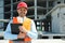 Professional engineer in safety equipment with clipboard at construction site