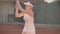 Professional equipped female beating hard the tennis ball with tennis racquet. Professional equipped female beating hard