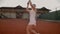 Professional equipped female beating hard the tennis ball with tennis racquet. Professional equipped female beating hard