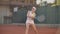 Professional equipped female beating hard the tennis ball with tennis racquet. Professional equipped female beating hard