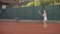 Professional equipped female beating hard the tennis ball with tennis racquet. Professional equipped female beating hard