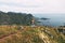 Professional expeditor standing on the edge cliff rock and looking forward away. Wanderlust