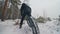 Professional extreme sportsman biker riding fat bike in outdoor. Close-up view of rear wheel. Cyclist ride in winter