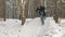 Professional extreme sportsman biker riding fat bike in outdoor. Cyclist ride in winter snow forest. Man does trial