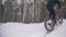 Professional extreme sportsman biker riding a fat bike in outdoors. Cyclist ride in the winter snow forest. Man does