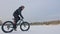 Professional extreme sportsman biker riding a fat bike in outdoors. Cyclist ride in the winter on snow ice. Man does