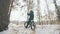 Professional extreme sportsman biker sit a fat bike in outdoor. Cyclist recline in the winter snow forest. Man walk with