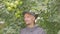 Professional farmer in uniform picking apples in a orchard. Very good harvest of apples