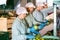 Professional female employees in uniform sorting fresh apples on producing grading line