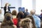 Professional Female Lecturer Speaking In Front of the Group of People At The Conference