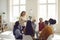 Professional female psychologist listens and gives advice to people at a support group meeting.