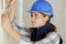 Professional female worker stripping wallpaper