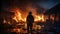 A professional firefighter puts out the flames. A burning house and a man in uniform, view from the back.