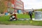 Professional firefighters, rescuers in protective fireproof suits, helmets and gas masks flee people from an industrial building i