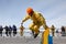 A professional fireman in a special suit jumps over a barrier .Regional fire-fighting in the training area with urban and contract