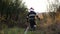 Professional fireman in uniform running for equipment that is in a red truck. Male firefighter jogging through lawn to