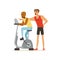 Professional fitness coach and man working out on exercise bike, people exercising under control of personal trainer