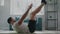 Professional fitness trainer practices toe touches exercise