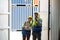 Professional foreman work at Container cargo site check up  goods in container. Workers are opening containers for inspection and