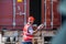 Professional foreman work at Container cargo site check up goods in container. Workers are opening containers for inspection and c