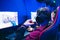 Professional gamer playing online games tournaments pc computer with headphones, Blurred red and blue background