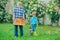 Professional Gardener at Work. Gardener cutting flowers in his garden. Farm family. Grandfather with his grandson