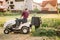 Professional gardner unloading grass from container. Worker using machinery for landscaping