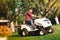 Professional gardner using lawn mower and cutting grass