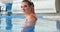 Professional girl swimmer in swimsuit poses in water at man
