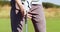 Professional golf player. Unrecognizable man wearing golf glove taking golf club and standing in hitting position