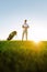 Professional golfer standing on field at sunset