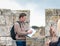 A professional guide stands on the city fortification wall and tells visitors about the old city of Jerusalem, Israel
