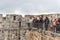 A professional guide stands with a group on the city wall and talks in old city of Jerusalem, Israel