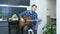 Professional guitarist tunes acoustic guitar at home. Young male musician tuning guitar at home studio