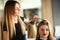 Professional Hairdresser Combing Girl Client Hair