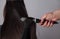 Professional Hairdresser female drying caucasian woman`s hair